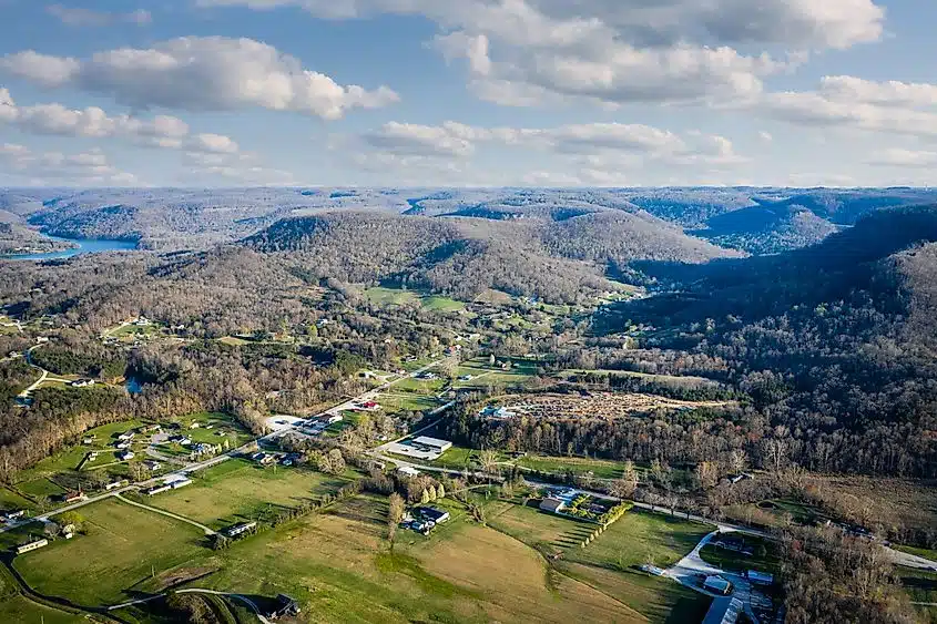 A view over the town of Berea, Kentucky, with wooded ridges behind it.