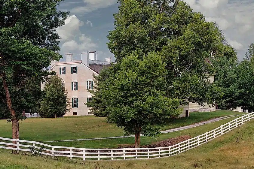 A white plank fence along a horse pasture at Shaker Village of Pleasant Hill near Harrodsburg, Kentucky.